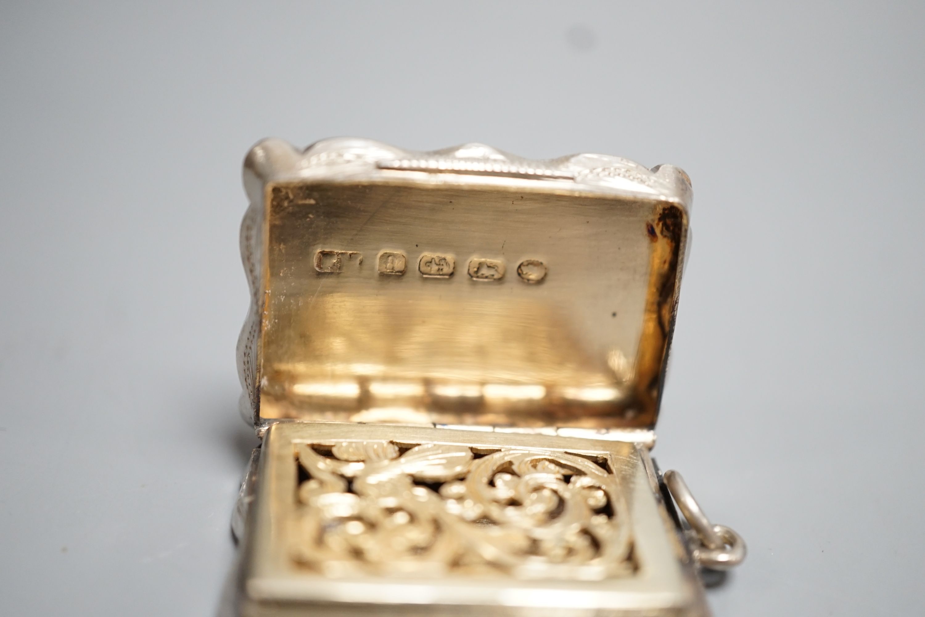 A Victorian engine turned silver shaped rectangular vinaigrette, Frederick Marson, Birmingham, 1875, 32mm.